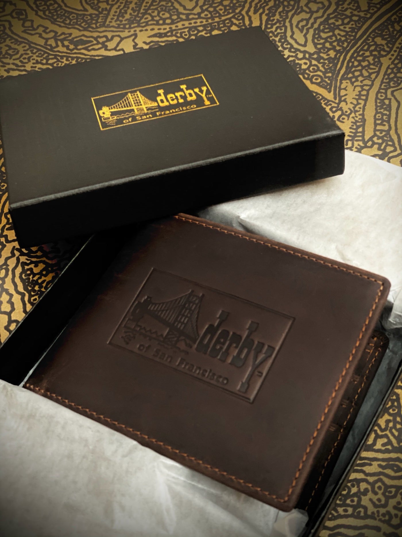 Brown leather Derby embossed logo wallet in box with gold logo