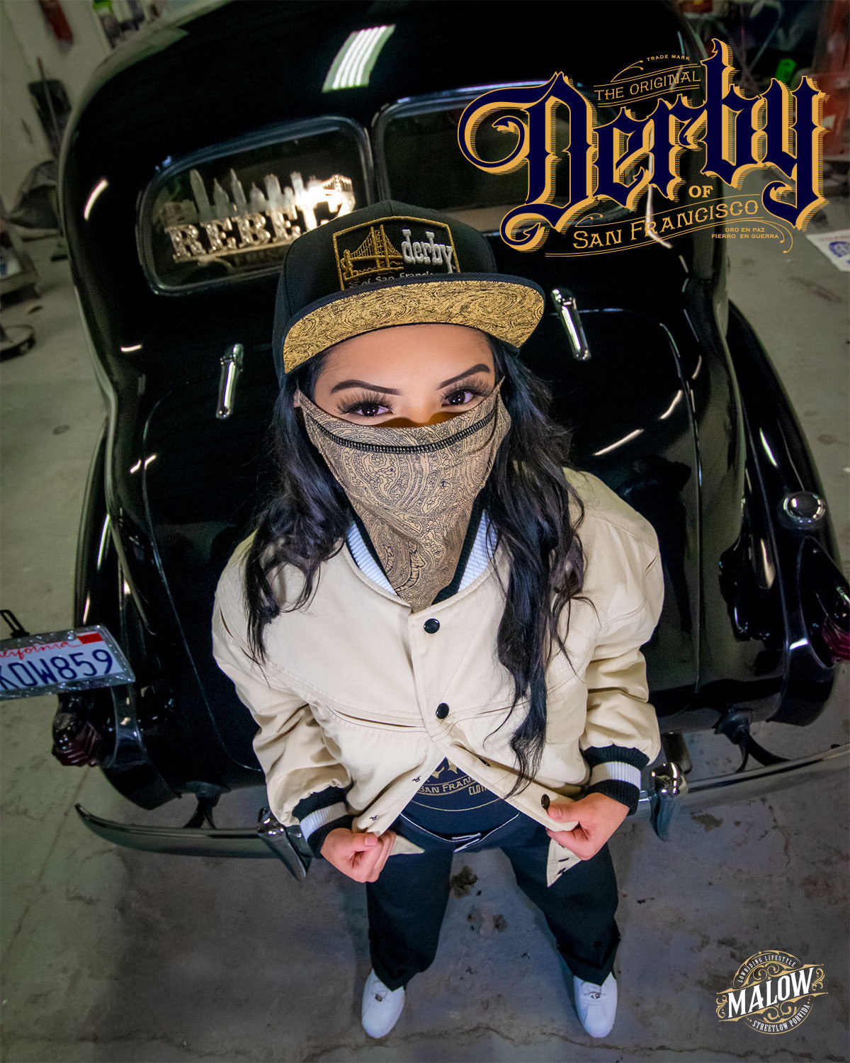 woman in derby jacket derby snapback hat derby mask in front of vintage car