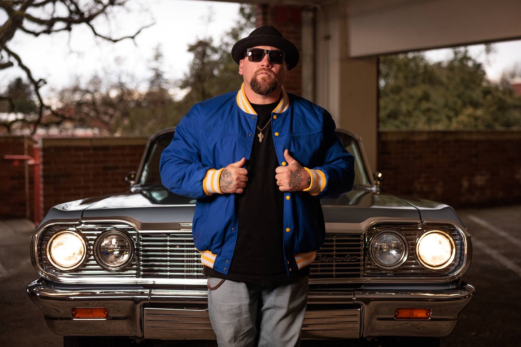 Man giving thumbs up in front of a classic car