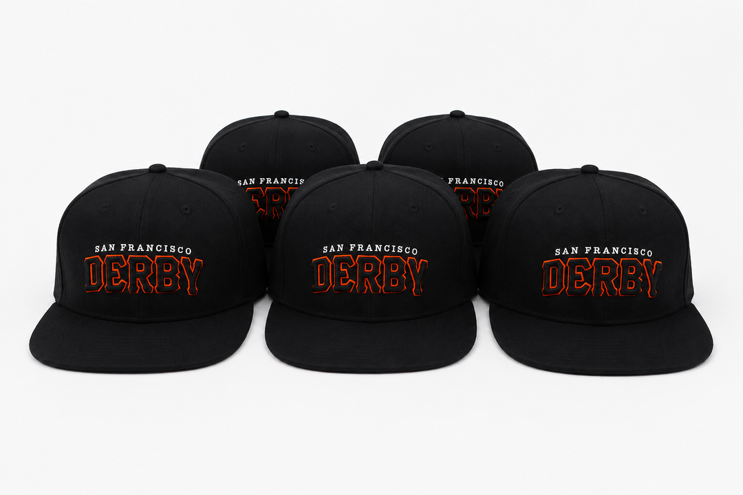Five black flat-brim snapback caps arranged in a row on a light gray background. Each cap features embroidered text reading &