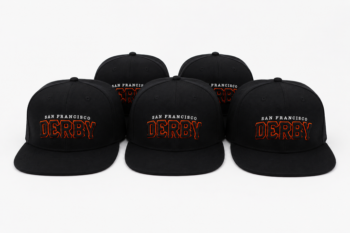 Five black flat-brim snapback caps arranged in a row on a light gray background. Each cap features embroidered text reading &